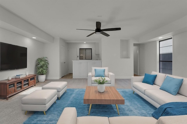 carpeted living room with ceiling fan