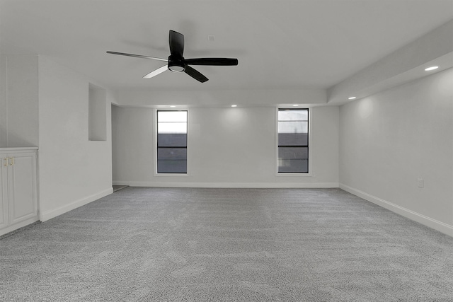 spare room featuring light carpet and ceiling fan