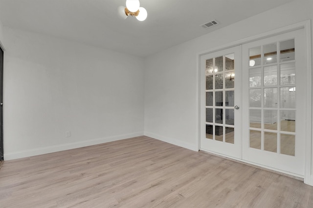 unfurnished room featuring light hardwood / wood-style floors and french doors