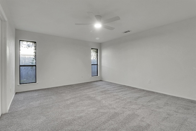 spare room with light colored carpet and ceiling fan