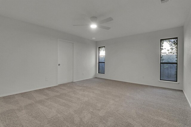 carpeted empty room featuring ceiling fan