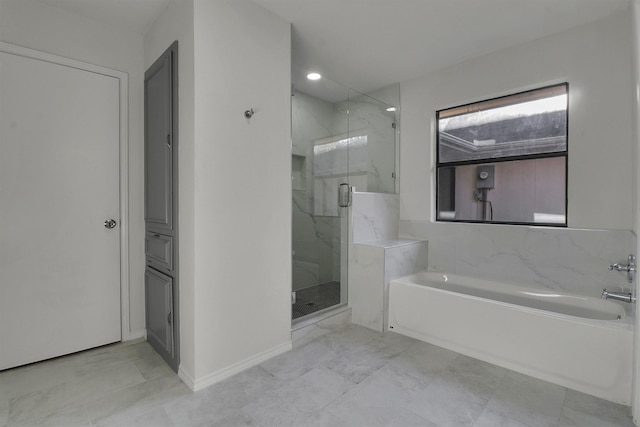 bathroom featuring shower with separate bathtub