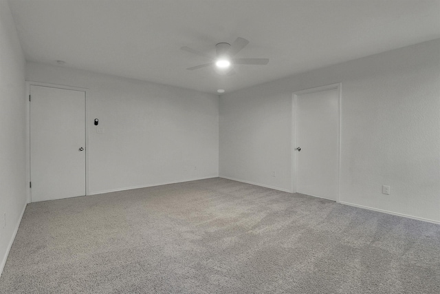 empty room with carpet floors and ceiling fan