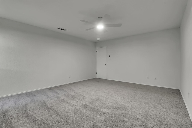 empty room featuring carpet flooring and ceiling fan