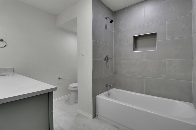 full bathroom featuring tiled shower / bath combo, vanity, and toilet