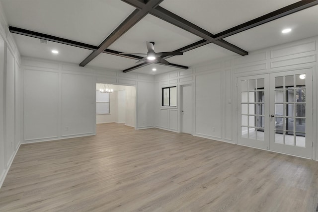 unfurnished room featuring coffered ceiling, ceiling fan with notable chandelier, beam ceiling, and light wood-type flooring