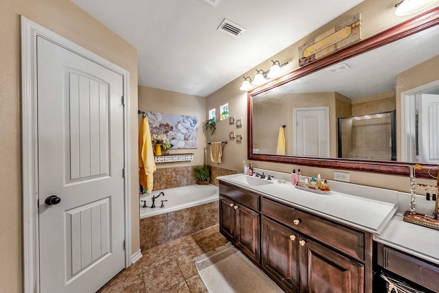 bathroom with tile patterned floors, vanity, and plus walk in shower