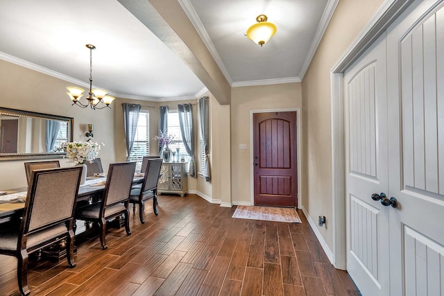 entryway featuring dark hardwood / wood-style floors, ornamental molding, and an inviting chandelier