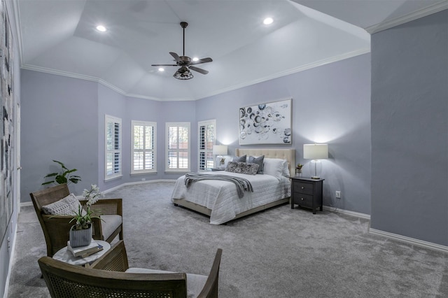 carpeted bedroom featuring lofted ceiling, a tray ceiling, ceiling fan, and crown molding