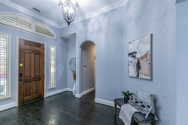 entrance foyer featuring crown molding, dark hardwood / wood-style floors, and an inviting chandelier