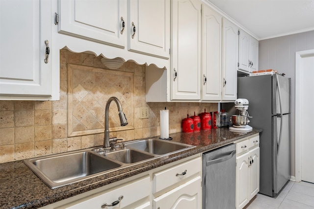 kitchen with stainless steel appliances, sink, and white cabinets