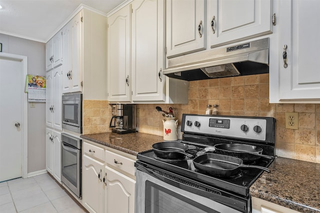 kitchen featuring decorative backsplash, stainless steel appliances, dark stone counters, and white cabinets