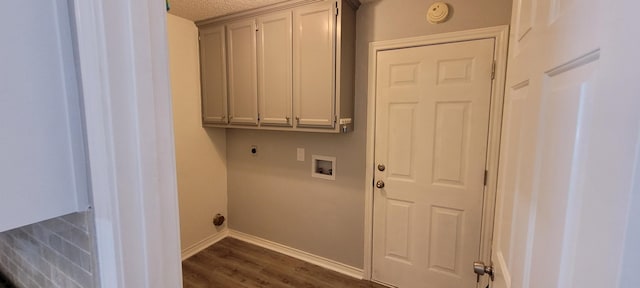 clothes washing area with cabinets, hookup for a washing machine, a textured ceiling, electric dryer hookup, and dark hardwood / wood-style floors