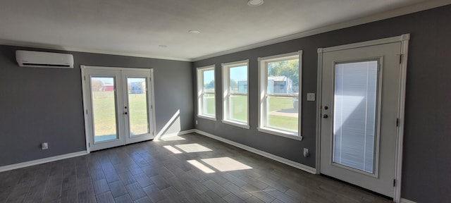 entryway featuring french doors, a wall mounted AC, plenty of natural light, and dark hardwood / wood-style floors