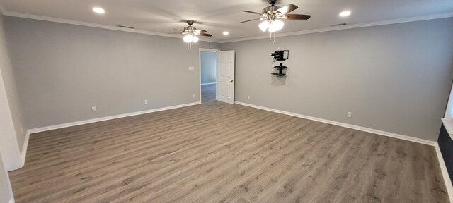 unfurnished room with hardwood / wood-style floors, ceiling fan, and crown molding