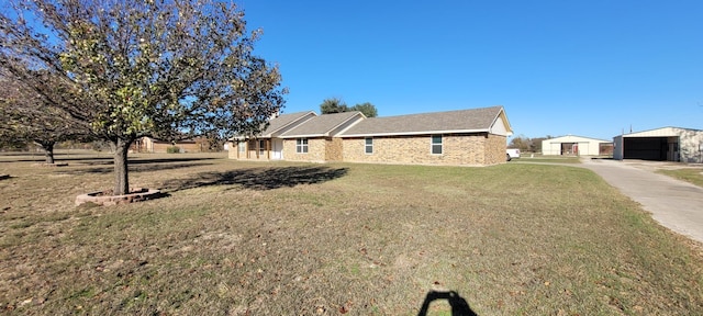 view of home's exterior featuring a garage, a yard, and an outdoor structure