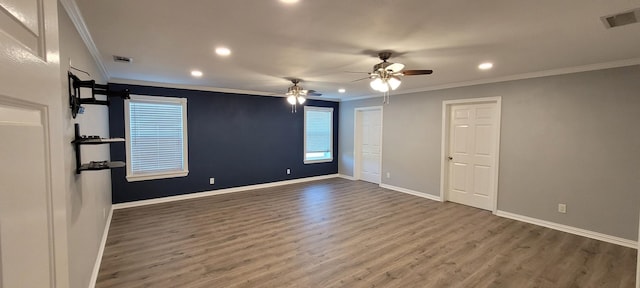 empty room with crown molding, dark hardwood / wood-style flooring, and ceiling fan