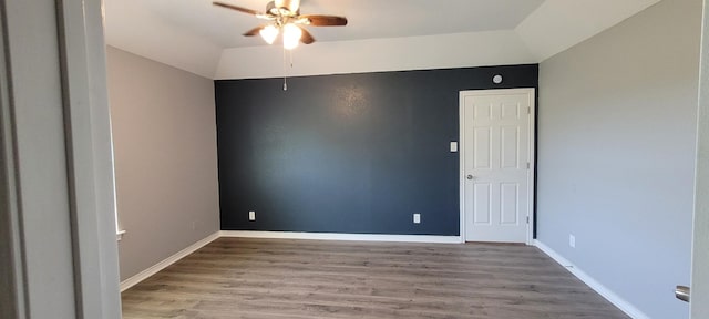 spare room featuring ceiling fan, light hardwood / wood-style floors, and lofted ceiling