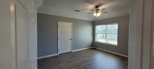 unfurnished bedroom featuring ceiling fan and dark hardwood / wood-style flooring