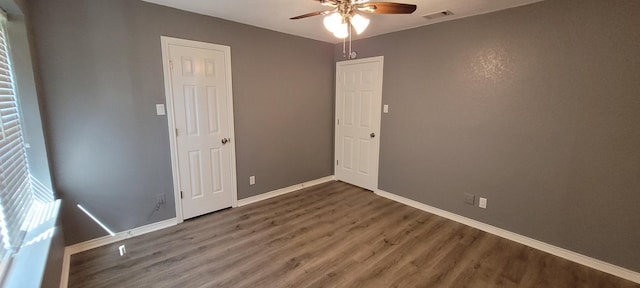 empty room featuring ceiling fan and dark hardwood / wood-style floors