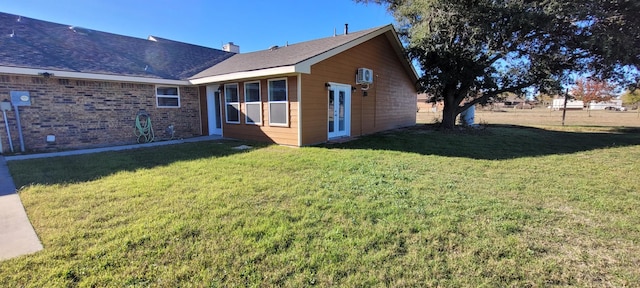 rear view of house with a yard