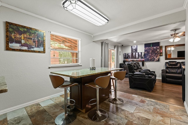 dining space with crown molding, ceiling fan, and wood-type flooring