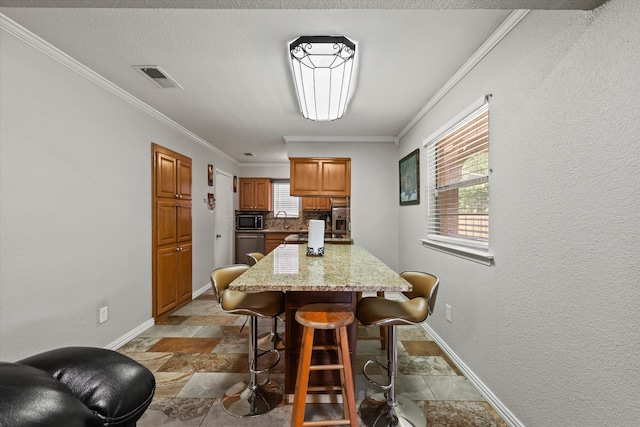 dining room with crown molding and sink