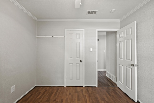 unfurnished bedroom with ornamental molding, a textured ceiling, ceiling fan, and dark wood-type flooring