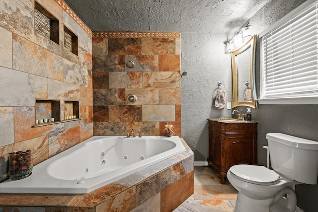 bathroom featuring vanity, toilet, and tiled tub