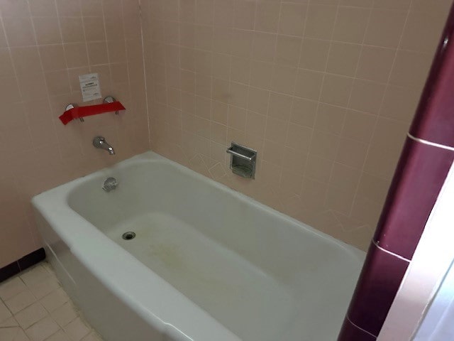 bathroom featuring a tub to relax in and tile patterned floors