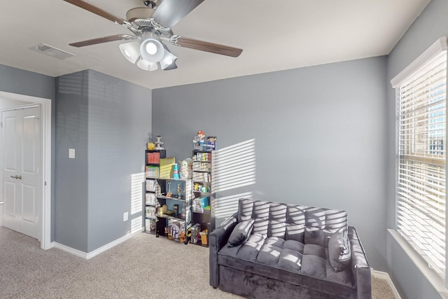 sitting room featuring ceiling fan and carpet