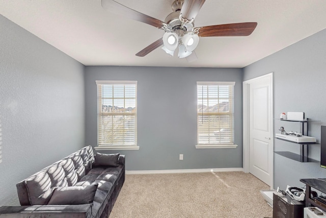 sitting room with a healthy amount of sunlight, light carpet, and ceiling fan