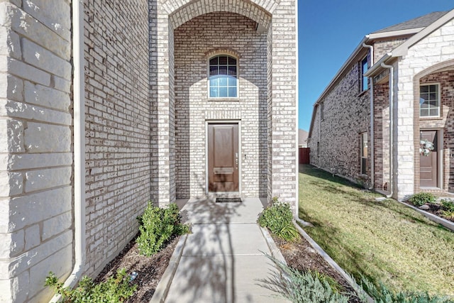 entrance to property with a yard