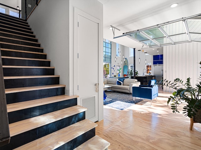 staircase featuring hardwood / wood-style floors