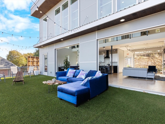 rear view of house featuring a patio, an outdoor hangout area, sink, and a lawn