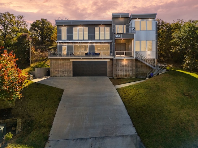 contemporary house featuring a yard and a garage