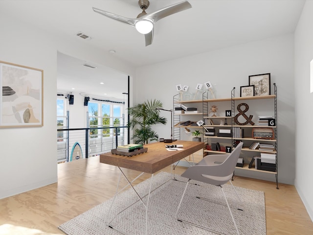 office with ceiling fan and light wood-type flooring