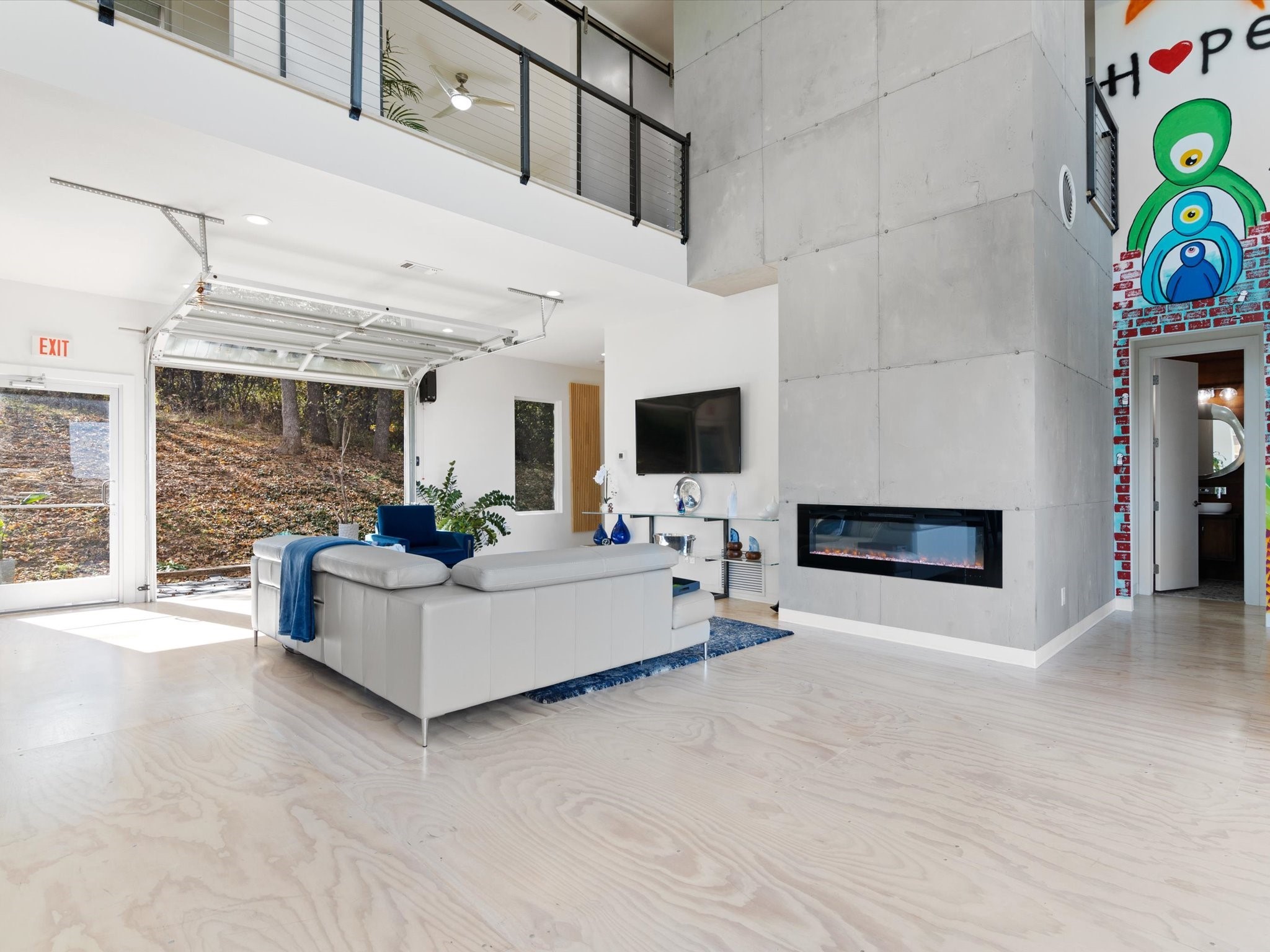 living room featuring a large fireplace and a towering ceiling