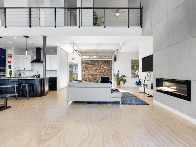 living room featuring a towering ceiling and sink