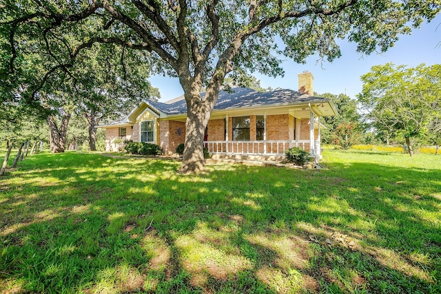 ranch-style house with covered porch and a front lawn