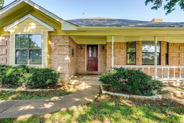 view of exterior entry with covered porch