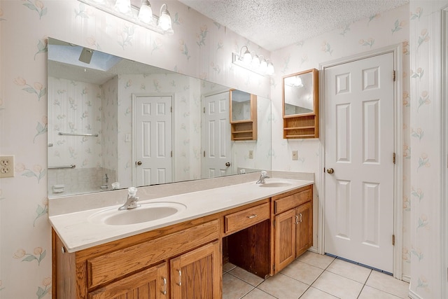 bathroom featuring tile patterned floors, vanity, and a textured ceiling