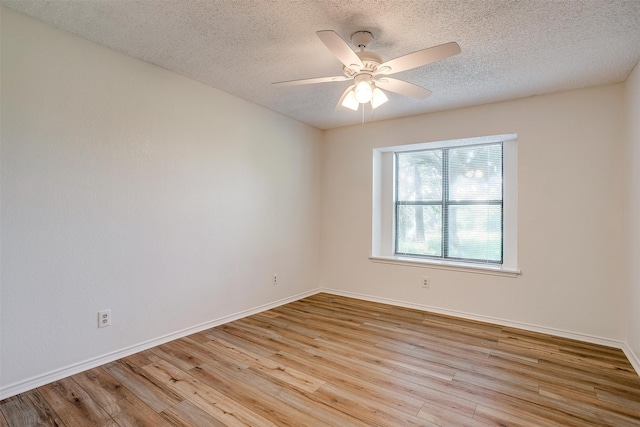 unfurnished room featuring ceiling fan, light hardwood / wood-style floors, and a textured ceiling