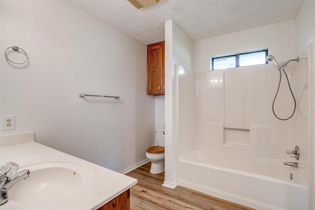 full bathroom with shower / bath combination, wood-type flooring, a textured ceiling, toilet, and vanity