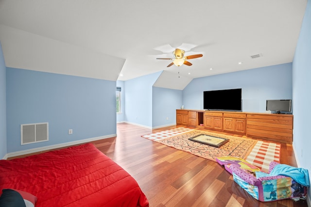 living room featuring ceiling fan, light hardwood / wood-style floors, and lofted ceiling