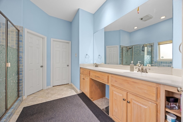 bathroom with tile patterned floors, vanity, and walk in shower