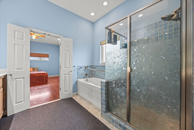 bathroom featuring tile patterned floors, ceiling fan, vanity, and plus walk in shower