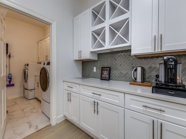 laundry area with cabinets and washing machine and clothes dryer