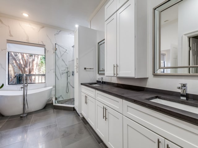 bathroom featuring tile patterned floors, vanity, and separate shower and tub