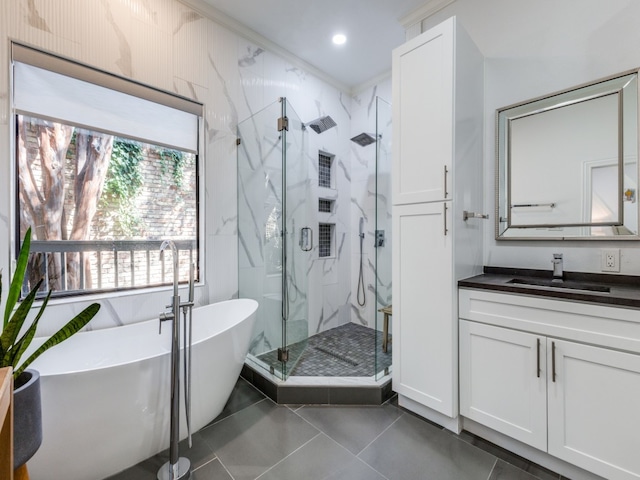 bathroom featuring tile patterned floors, vanity, ornamental molding, and shower with separate bathtub